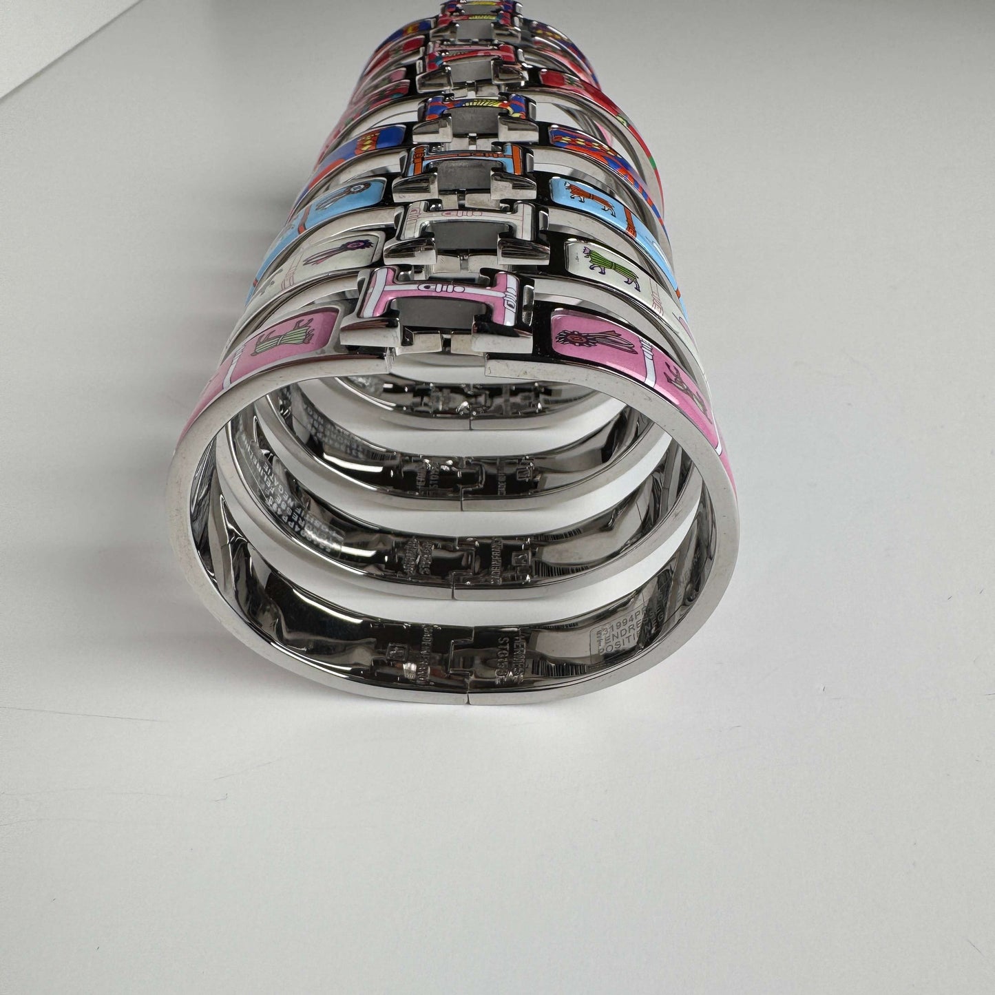 White gold printed enamel H bangles front view
