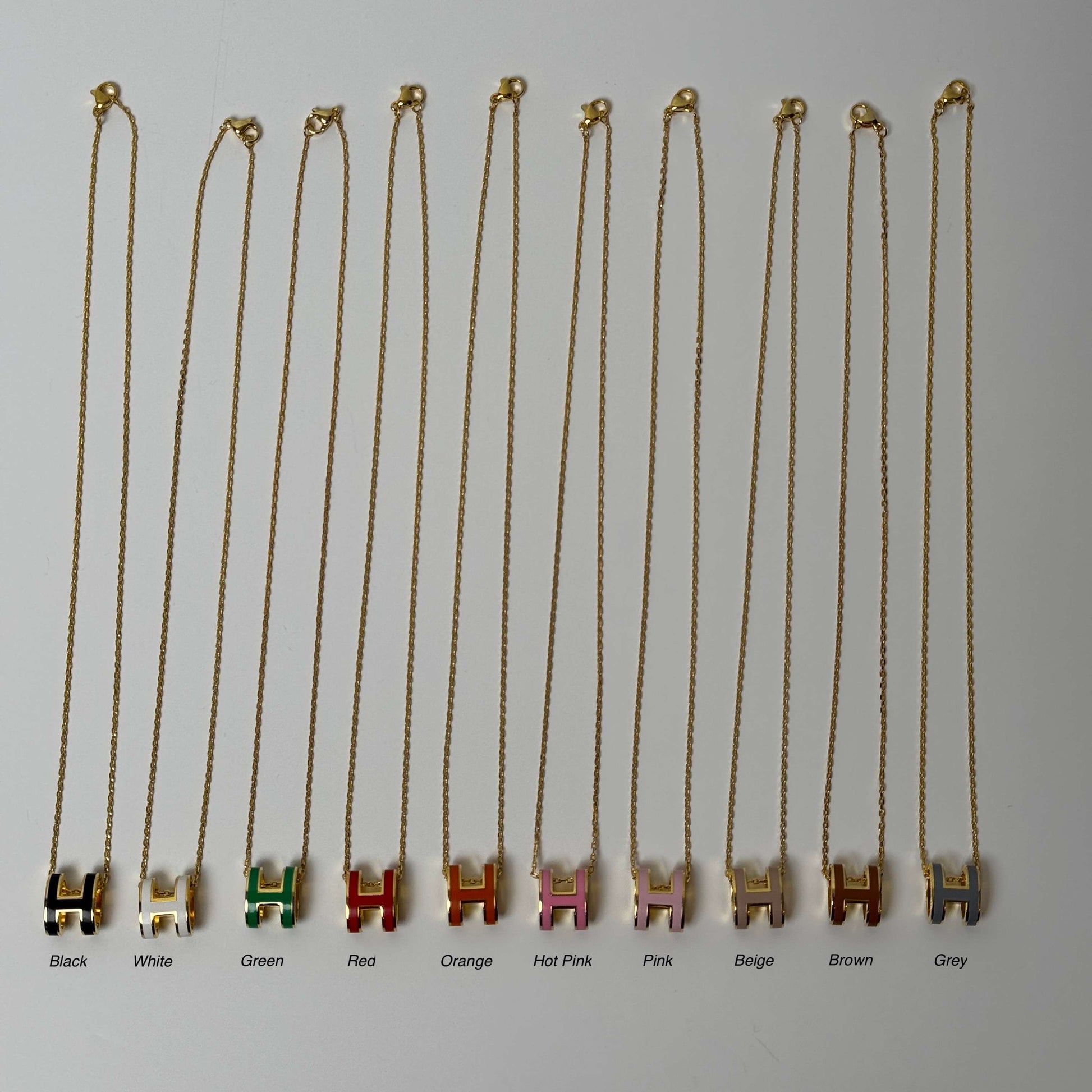 Yellow gold enamel H pendant necklace side view