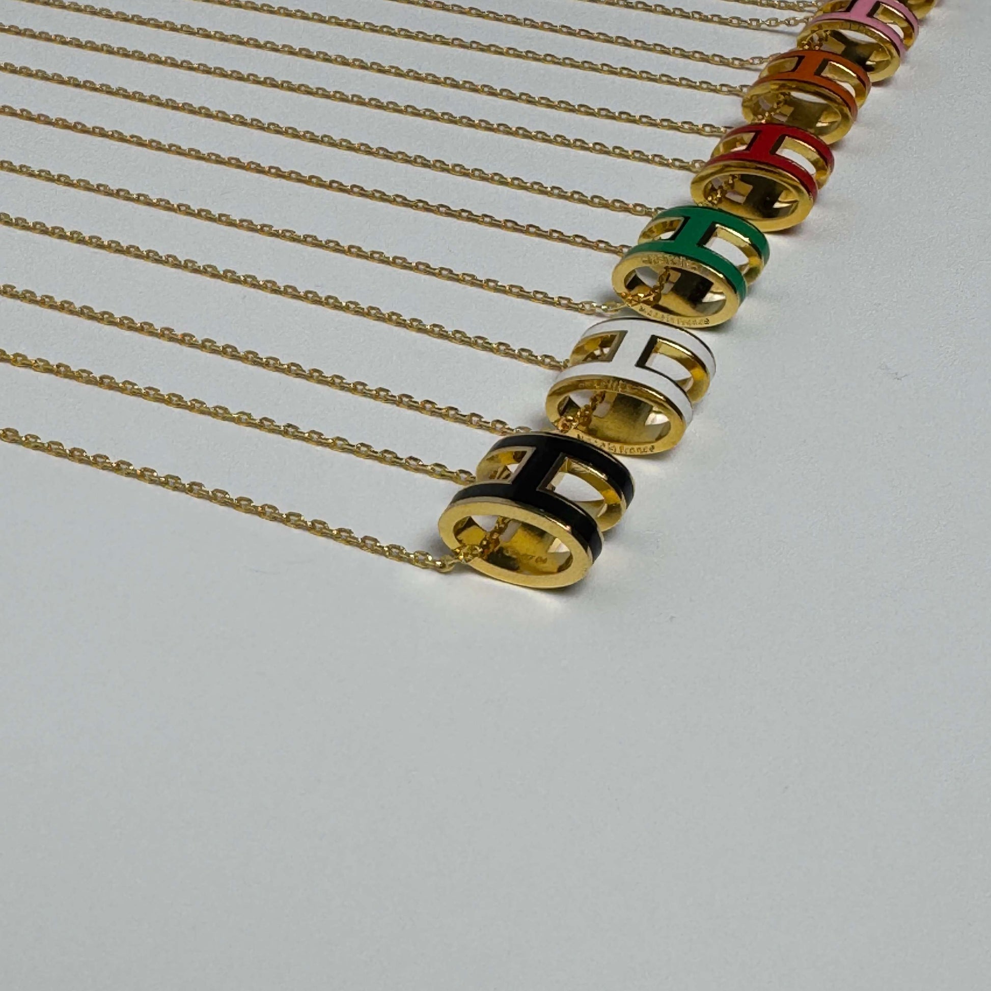 Yellow gold enamel H pendant necklace close-up