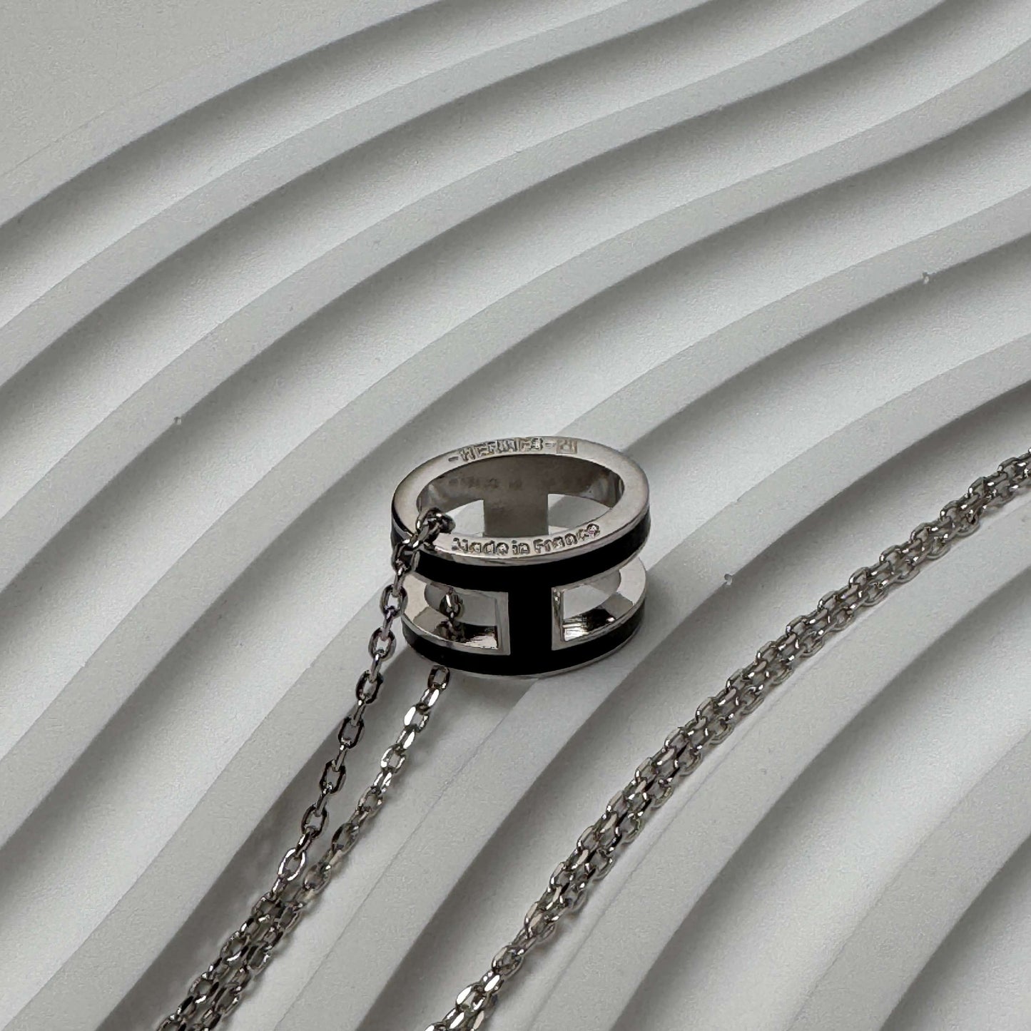 White gold enamel H pendant necklace close