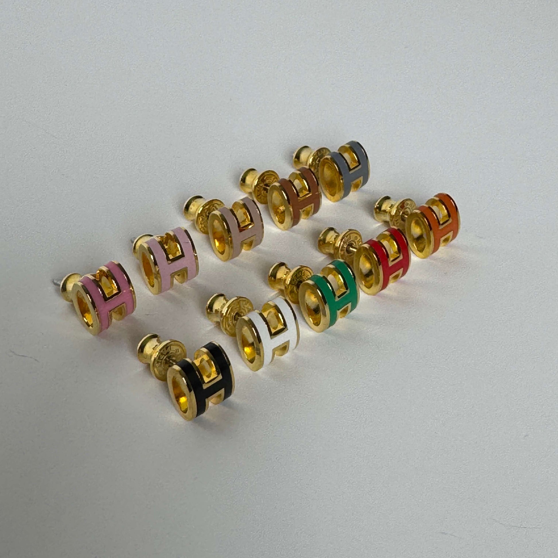 Yellow gold enamel H stud earrings in multiple colors