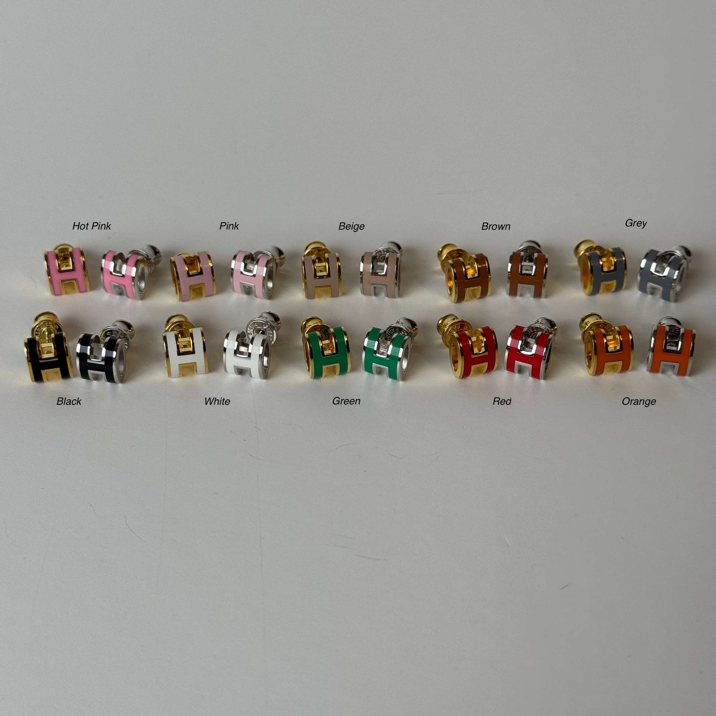 H stud earrings front view in multiple col