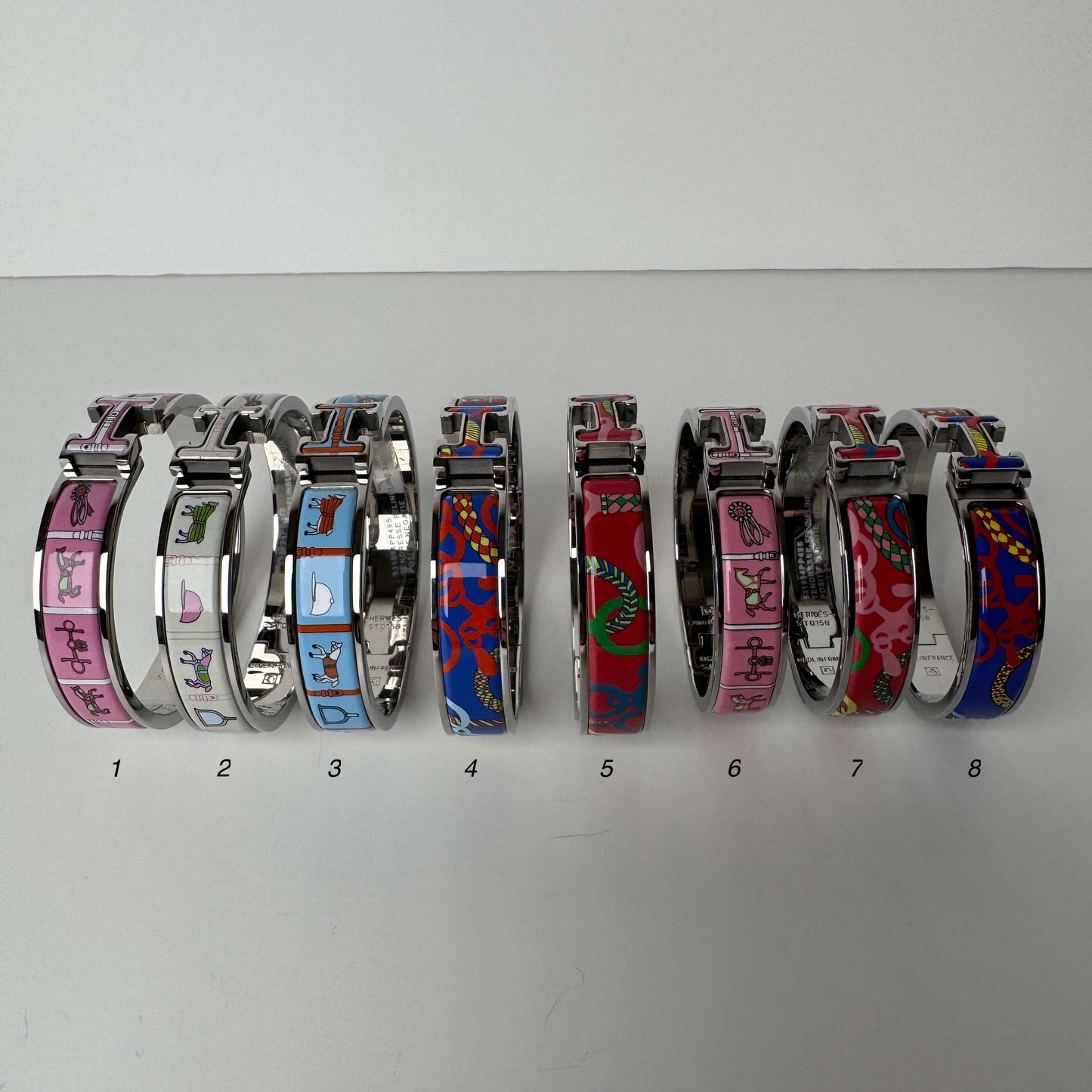 White gold printed enamel H bangles front view