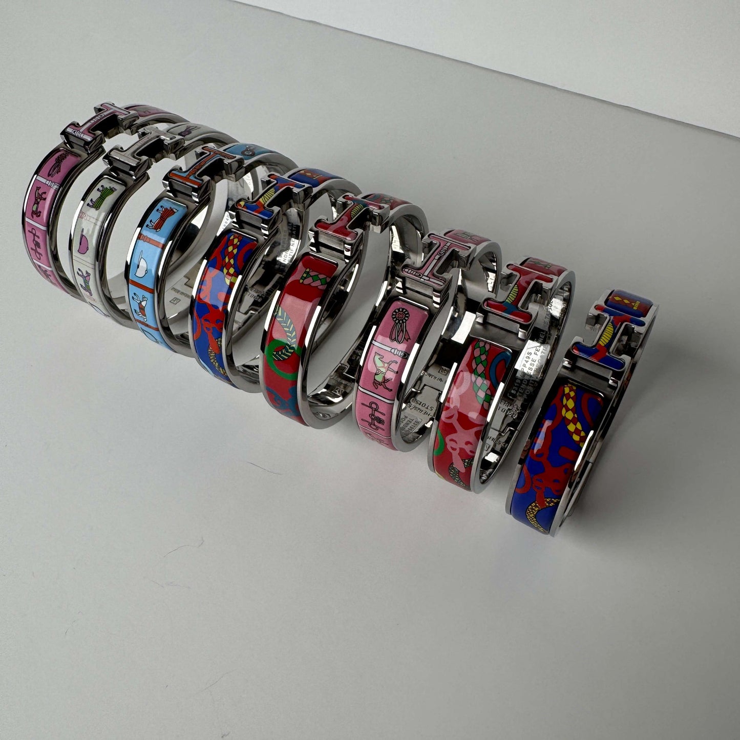 White gold printed enamel H bangles front view