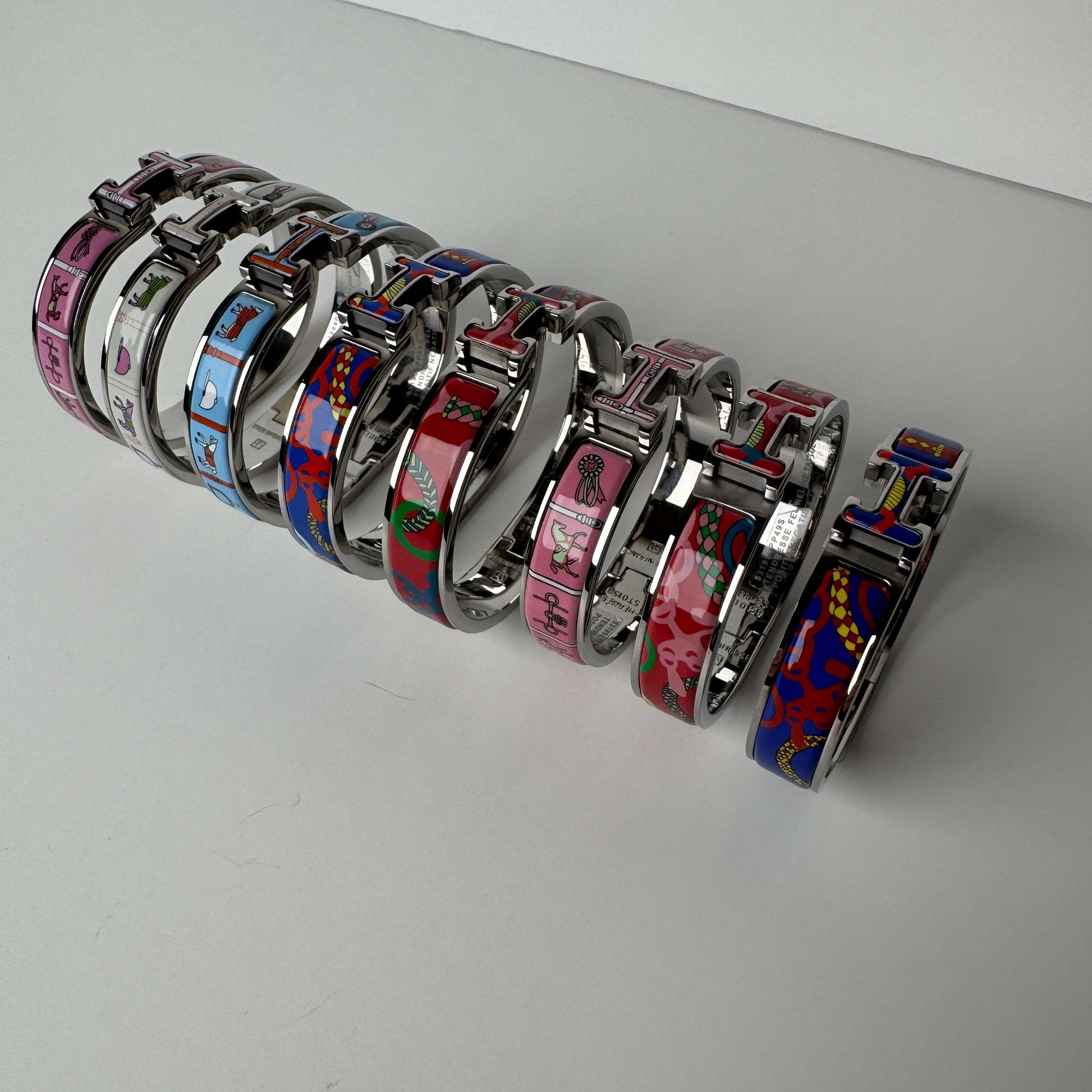 White gold printed enamel H bangles front view