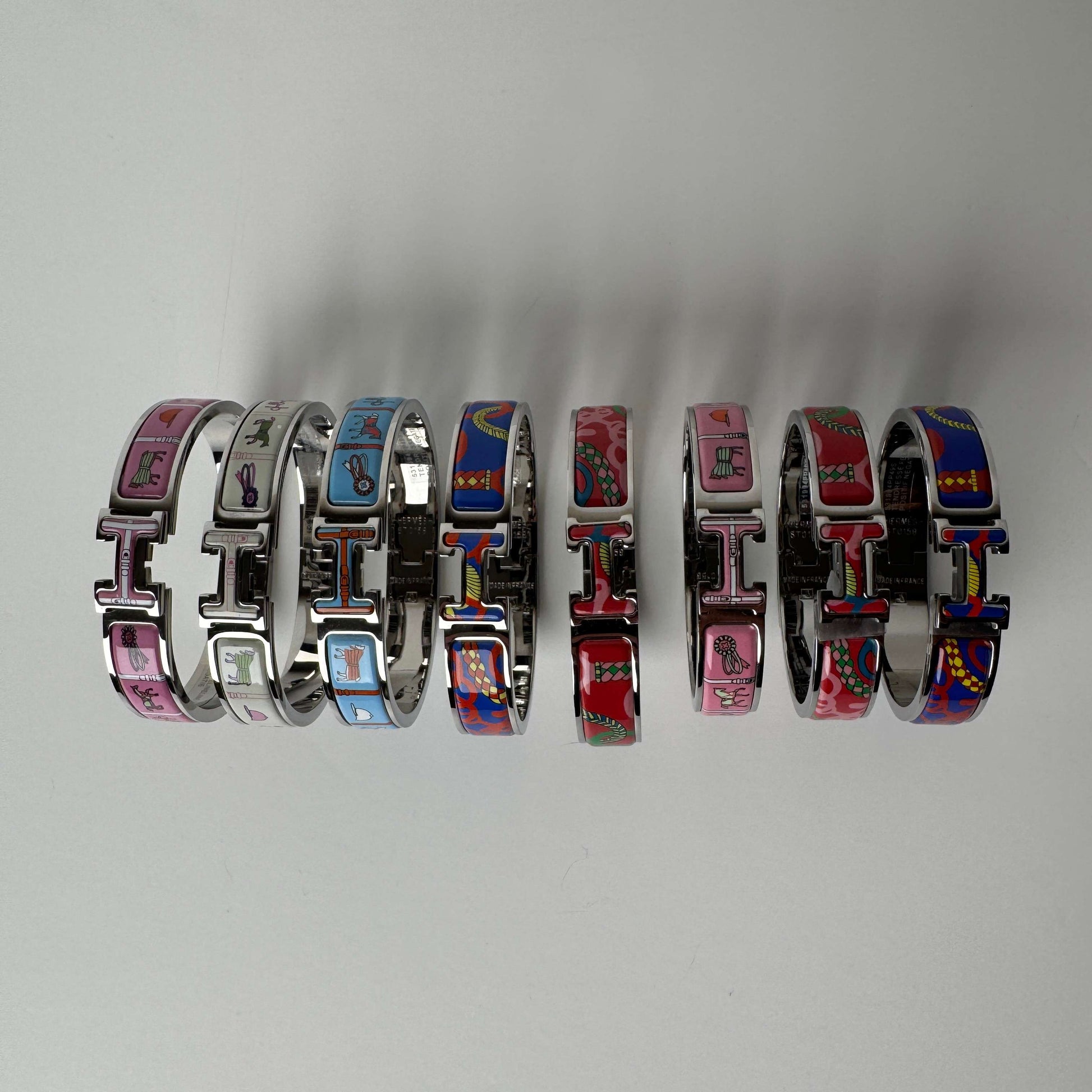 White gold printed enamel H bangles front view