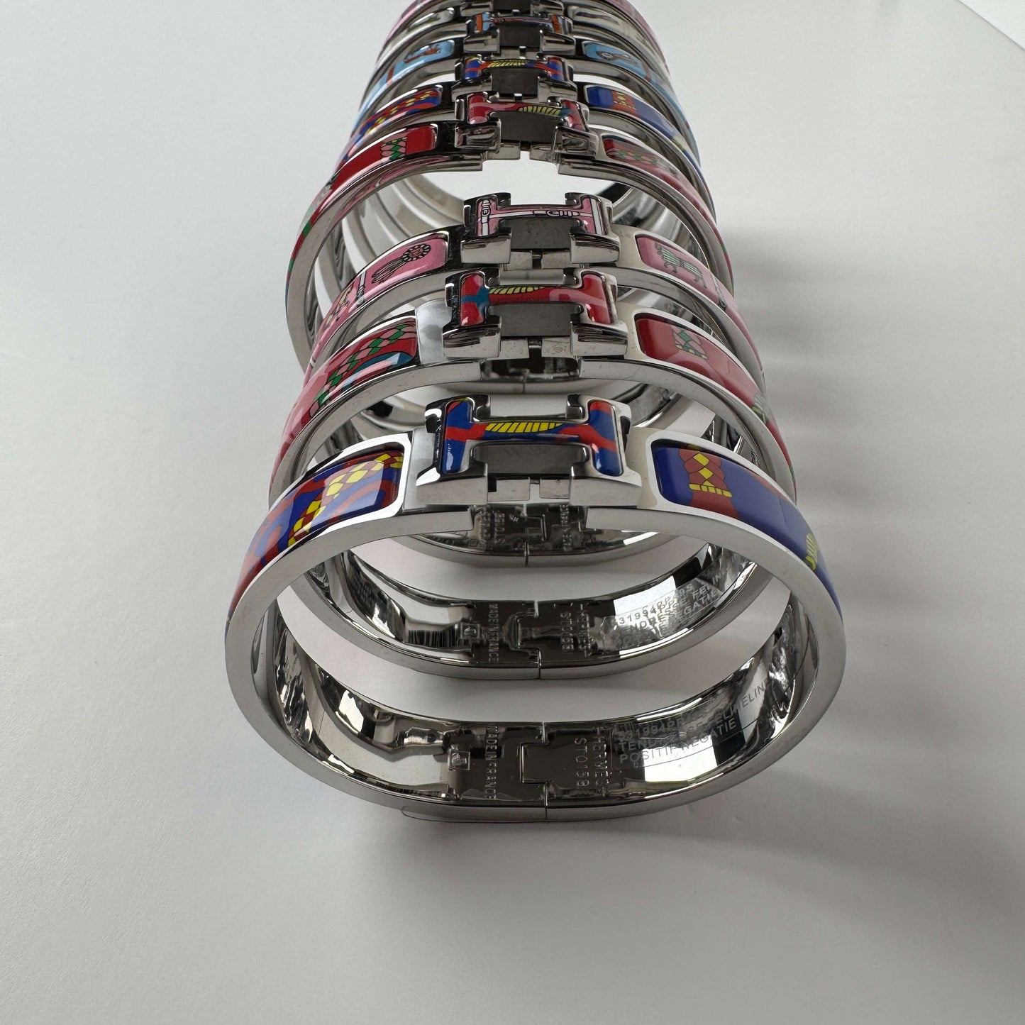 White gold printed enamel H bangles in multiple patterns