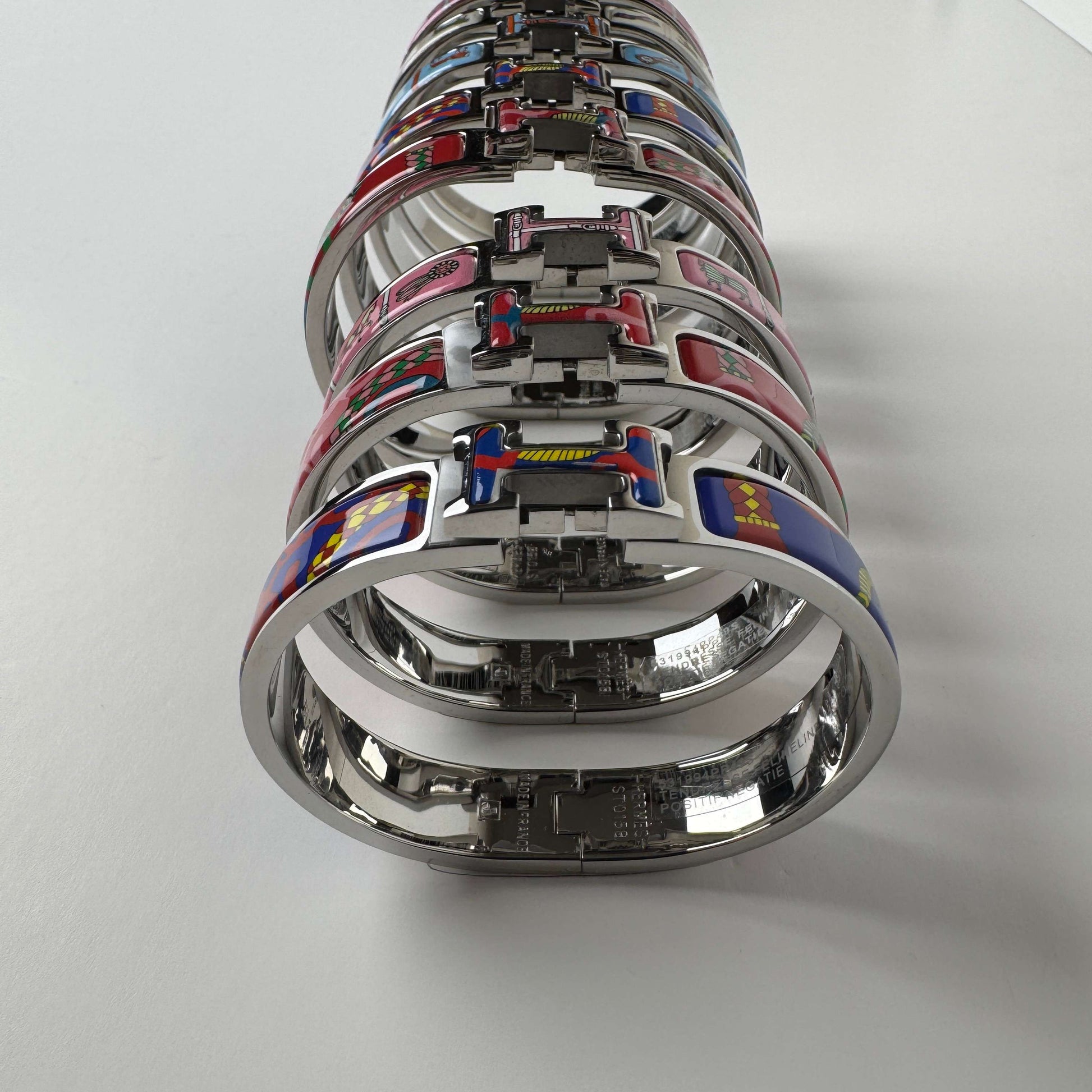White gold printed enamel H bangles in multiple patterns