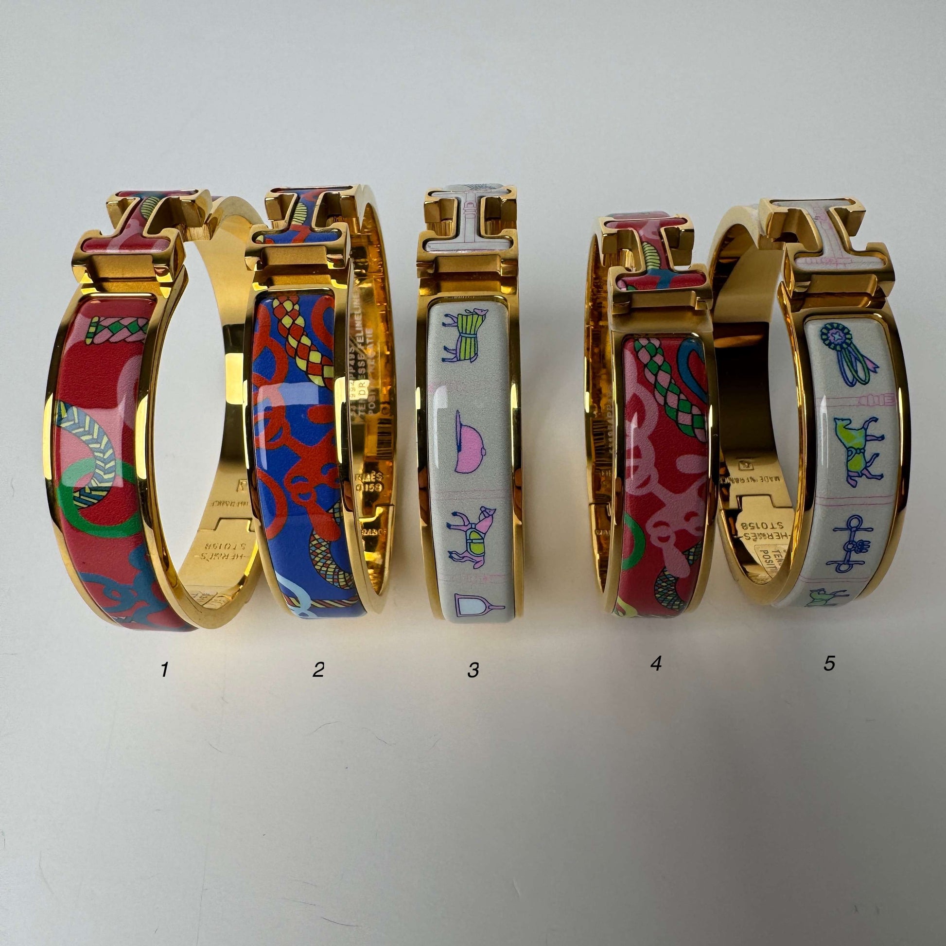 Yellow gold printed enamel H bangles in multiple patterns
