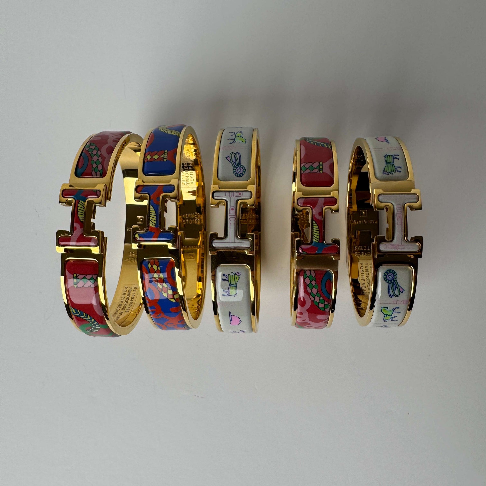 Yellow gold printed enamel H bangles in multiple patterns