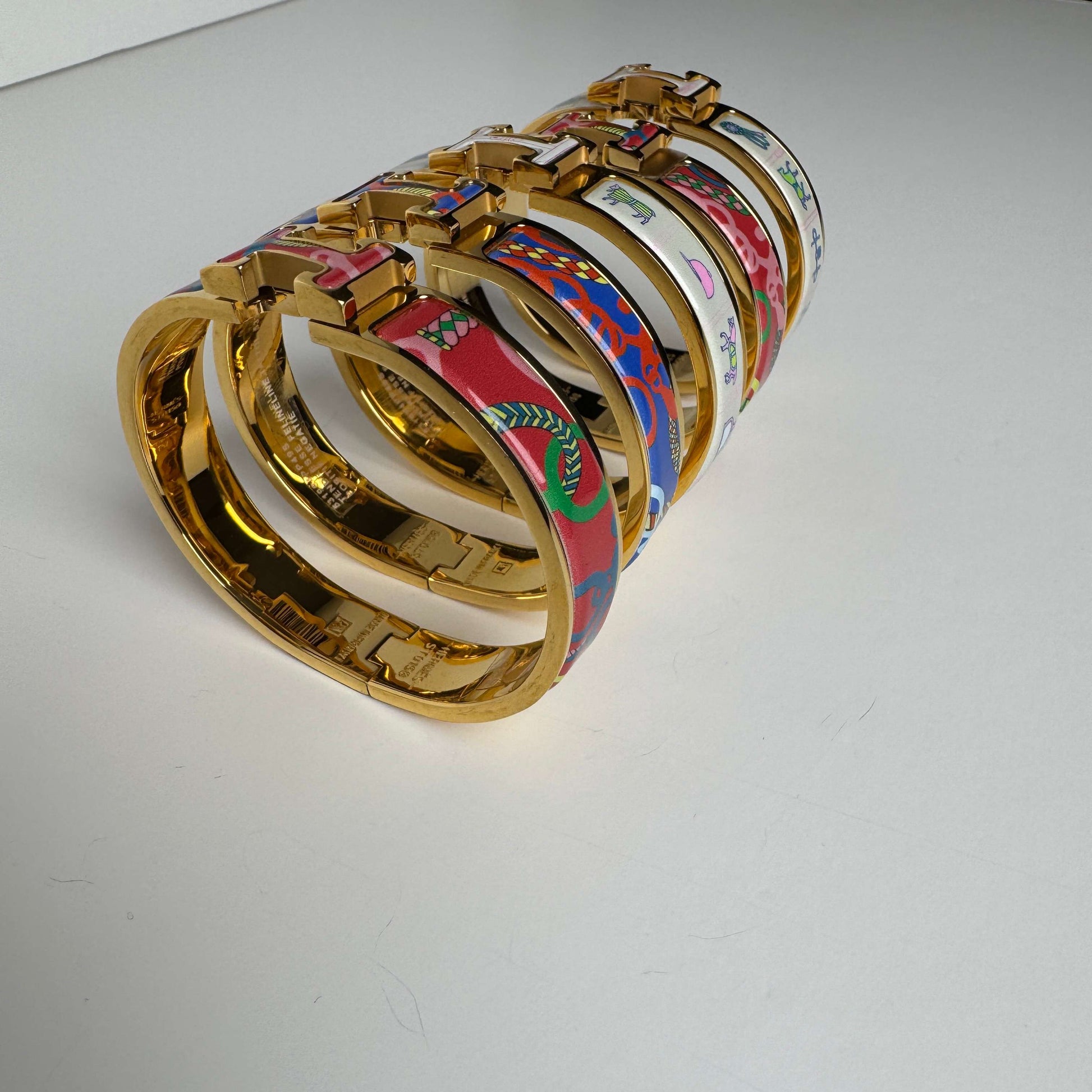 Yellow gold printed enamel H bangles stacked view