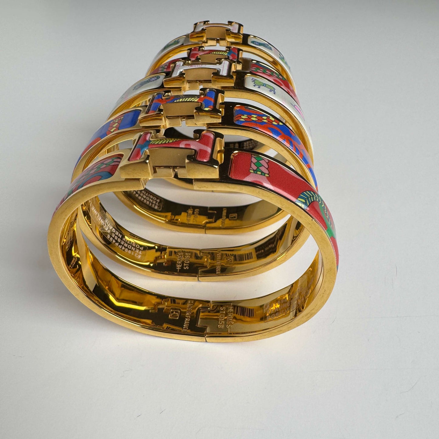 Yellow gold printed enamel H bangles front view