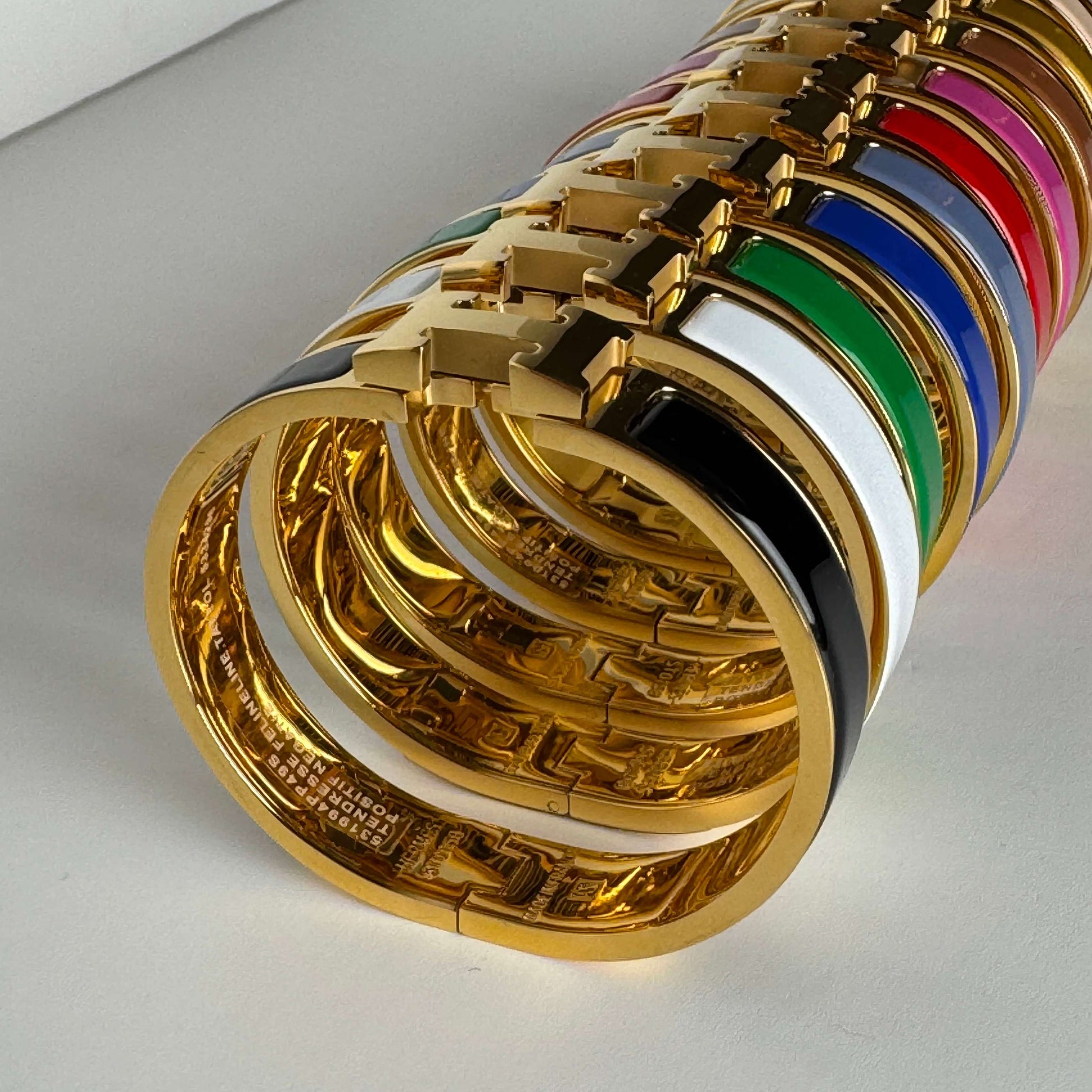 Yellow gold enamel H bangles stacked view